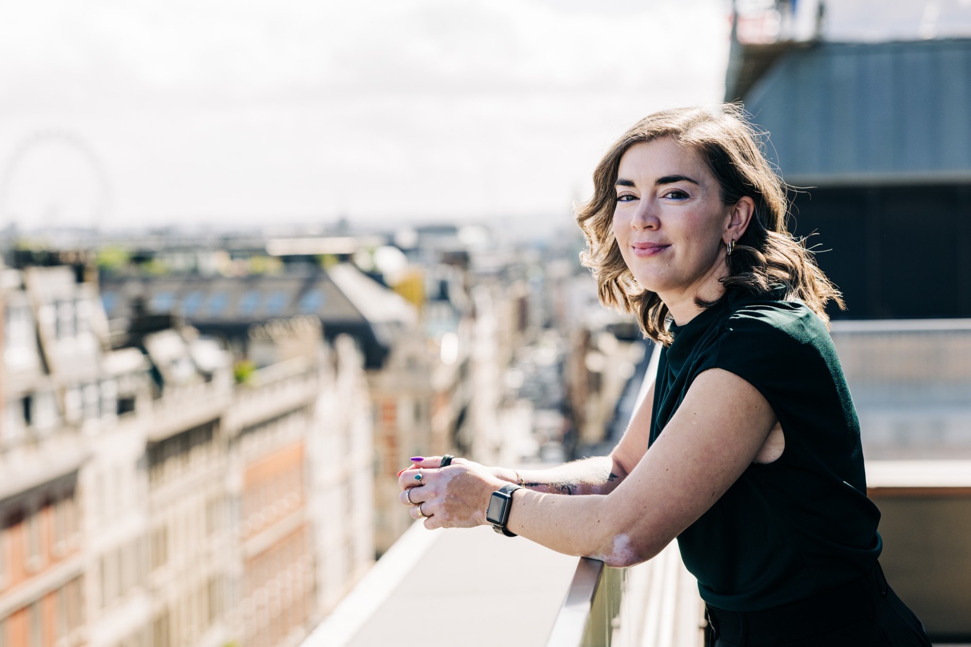 Jancis leaning on a balcony rail, looking out across the London skyline